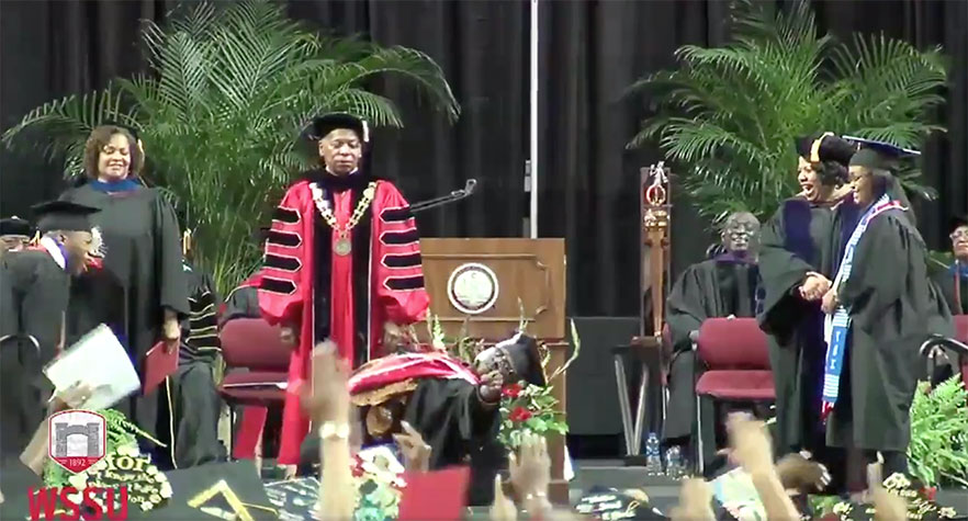 students celebrate on stage during commencement