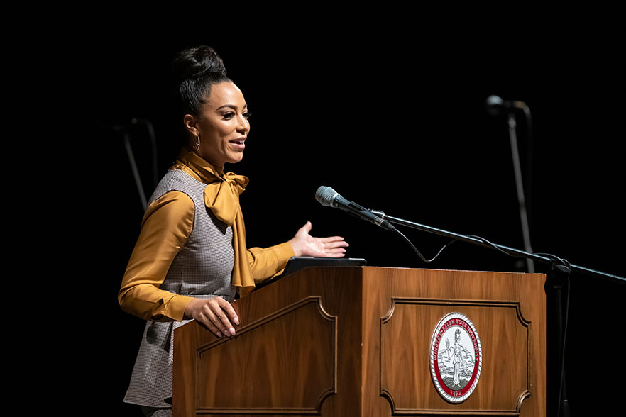 Angela Rye speaks from podium