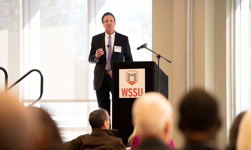 Jim Wolfson stands at the podium