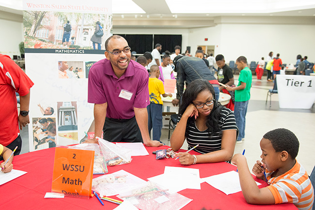 Camp youth working with mathematics during STEM day at a table