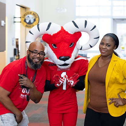 Employees standing with Amon the Ram