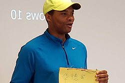 a man showing a notepad with a picture and Chinese writing