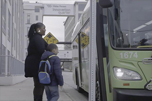 a mother and son getting on a bus