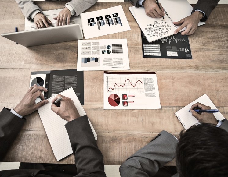 a group of people working on various pieces of data